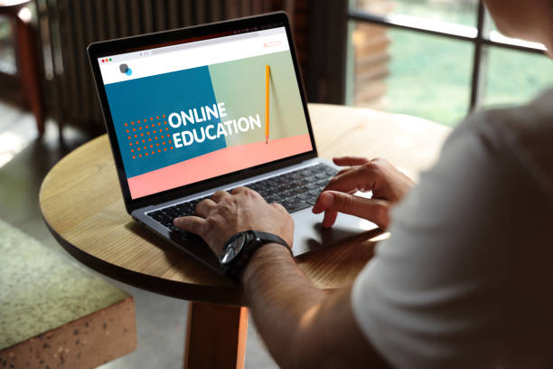Man using laptop with e-learning screen on a desk